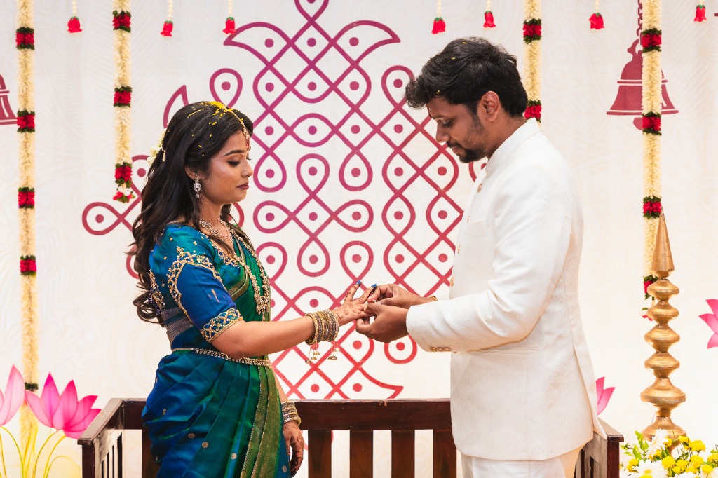 Ring Exchange — Karthik placing ring on Mirunalini's finger