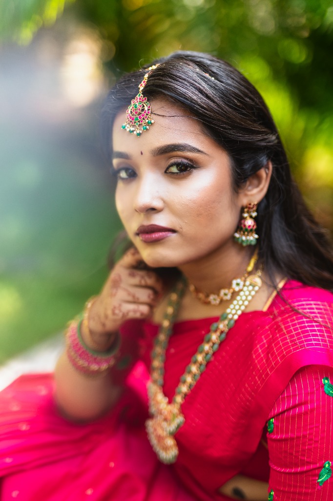Bride close-up portrait — Mehndi, maang tikka & jewellery in garden