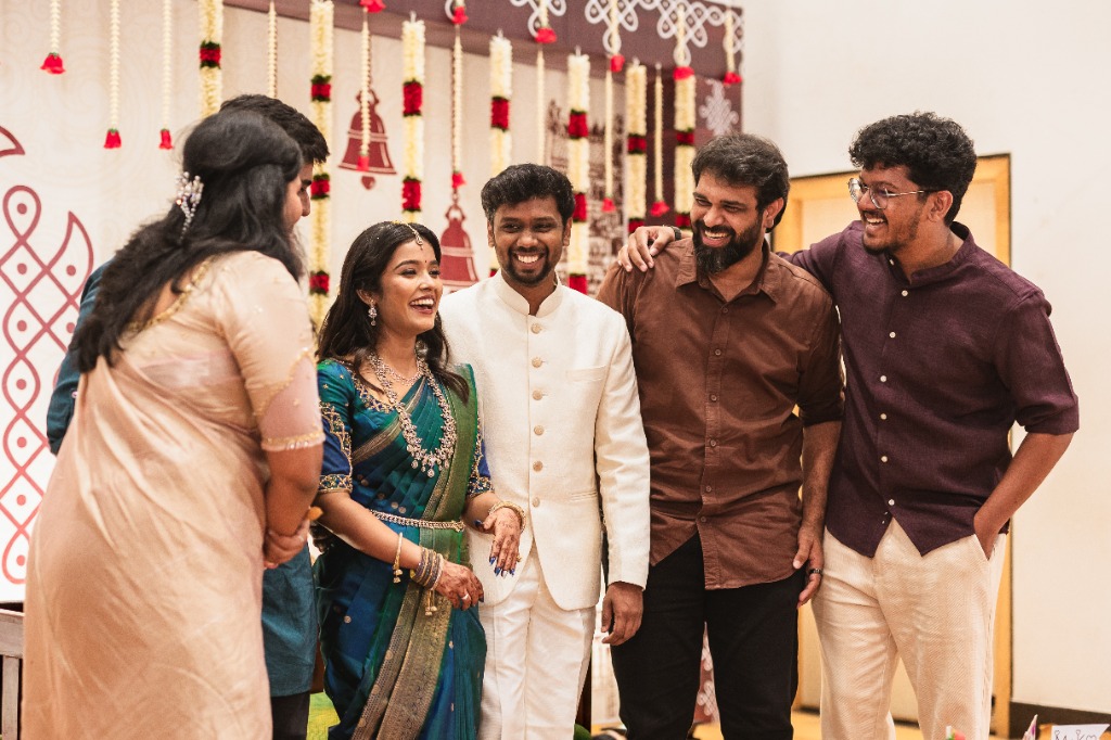 Engagement — Couple laughing with friends candid group moment