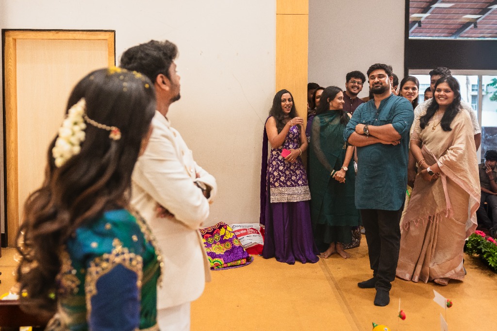 Engagement — Couple on stage, friends watching and smiling from hall