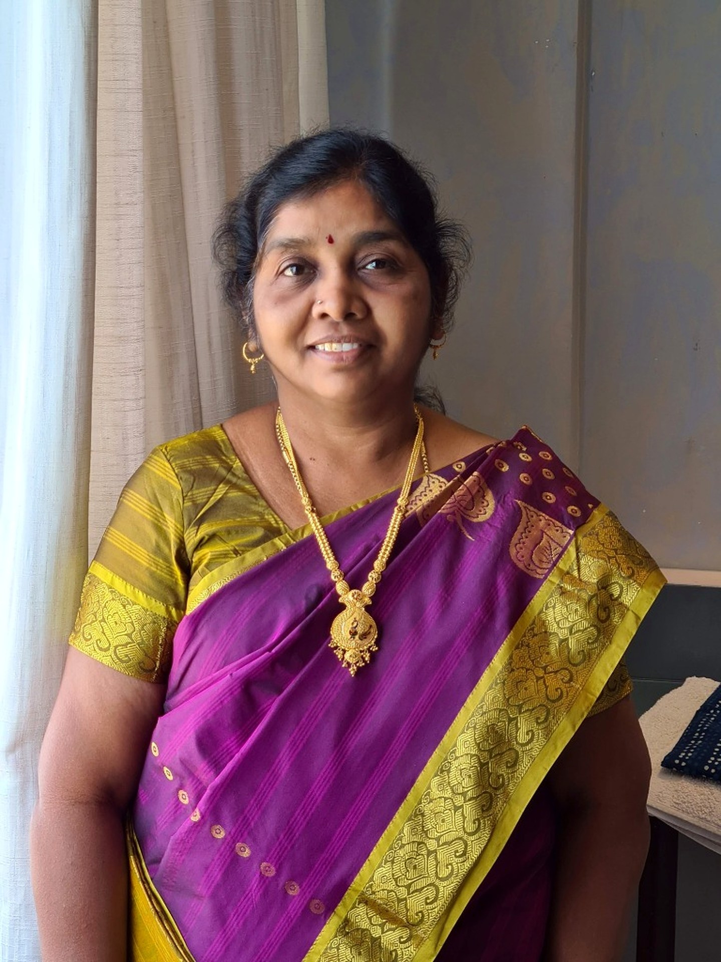 Mrs. R. Lakshmi Rajan — Karthik's Mother