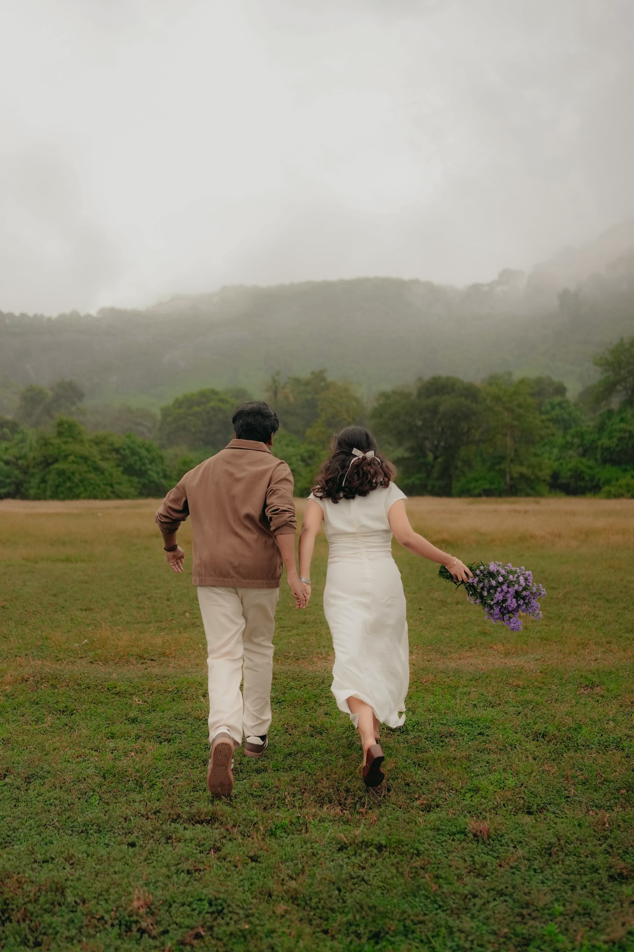 Pre-Wedding — Mirunalini hiding behind purple flowers, white dress in meadow