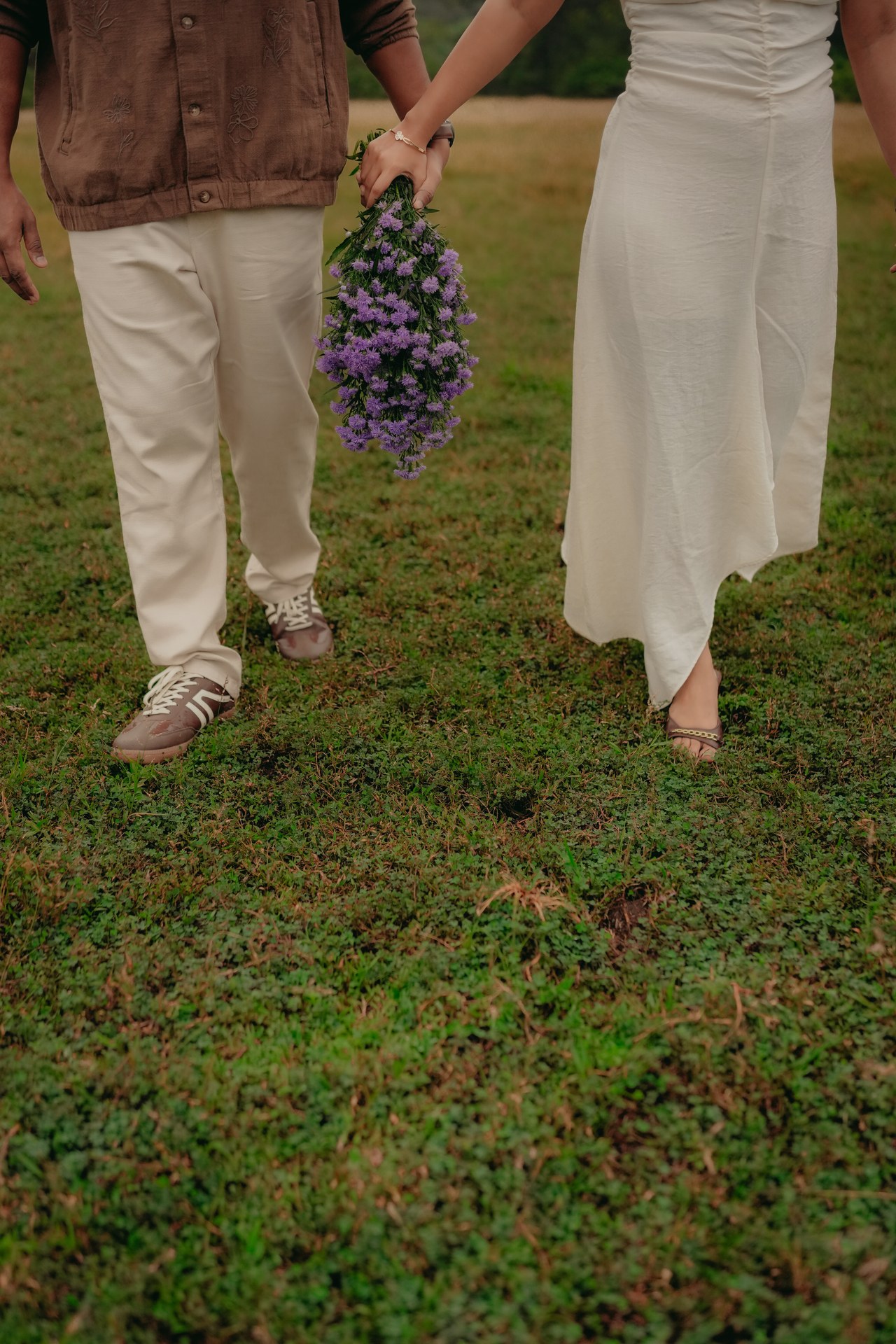 Pre-Wedding — Couple running hand-in-hand through green misty meadow